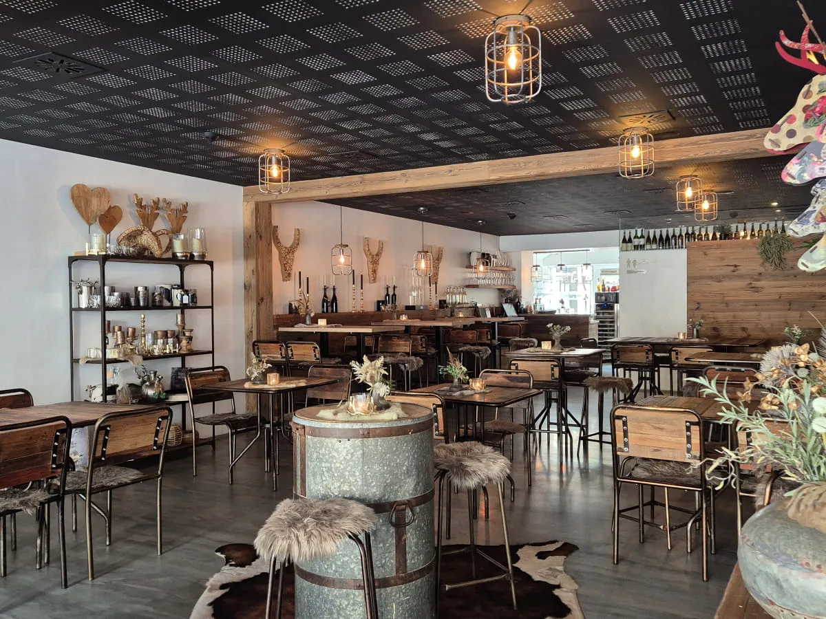 moderne Einrichtung eines Cafés mit Holzstühlen und Pflanzen
